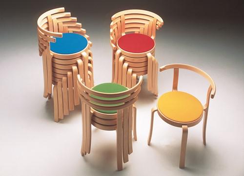 Vier torens met gestapelde stoelen met diverse kleuren zittingen uit de 800-serie van Magnus Olesen